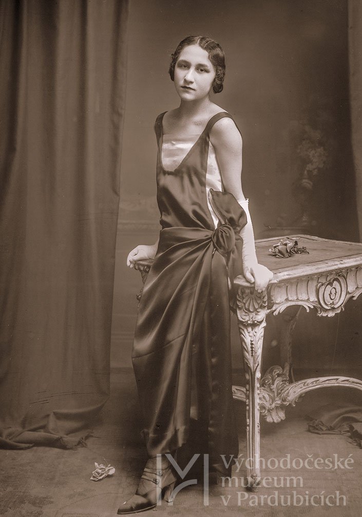 Ateliérová fotografie – mladá žena opírající se o stolek, 20. léta